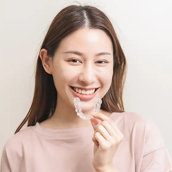 Photo of Patient Using Invisalign Aligners